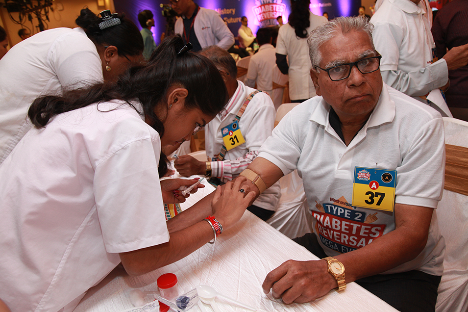 Senior citizen undergoing blood test at Madhavbaug Ayurvedic health check-up camp
